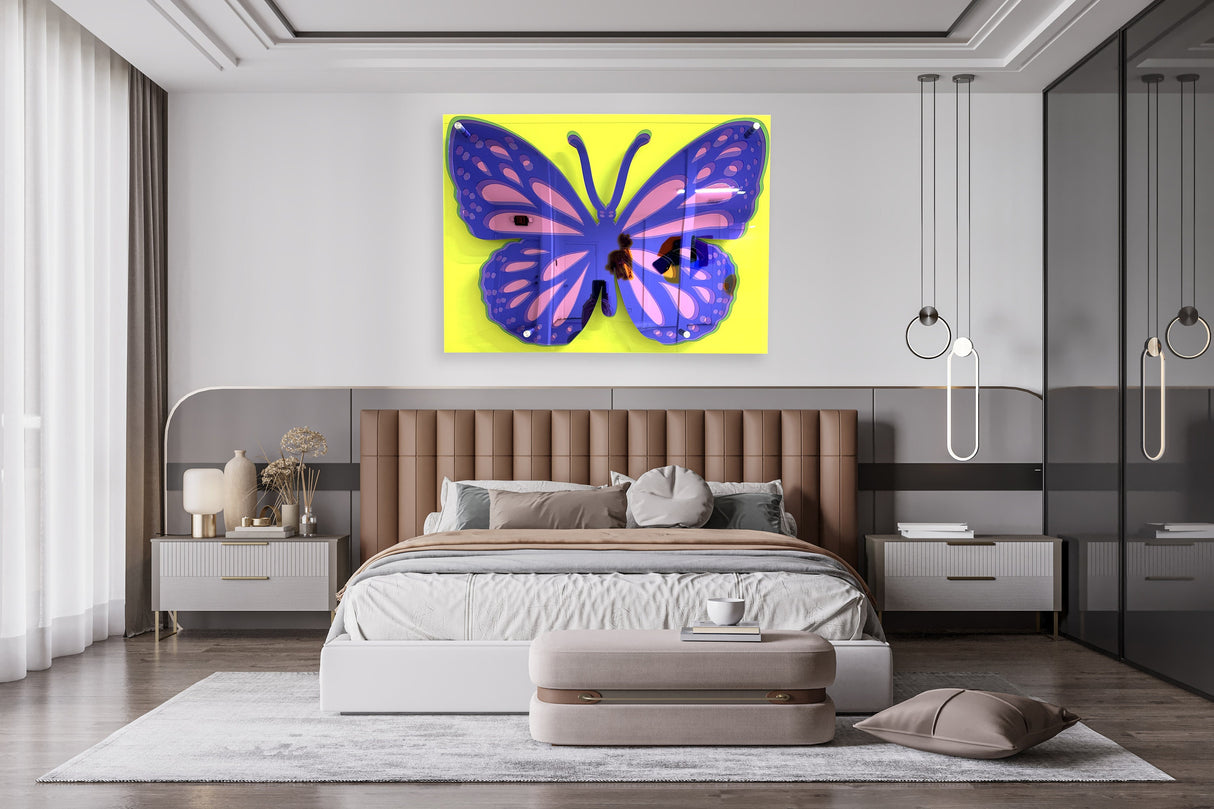 A modern bedroom showcases uniQstiQs Large Butterfly Art—a 3D acrylic pop art wall sculpture with a purple butterfly on yellow—adding vibrant, contemporary, abstract decor above the bed.