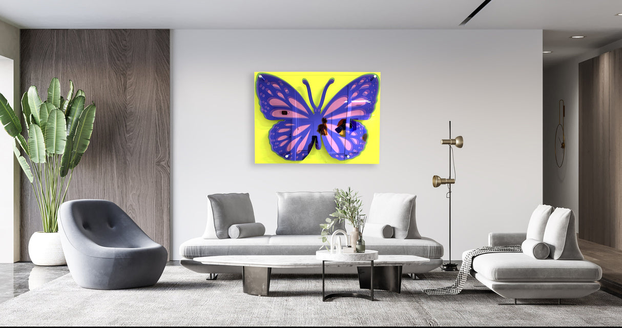 A modern living room with gray furniture features uniQstiQ’s Large Butterfly Art—an acrylic 3D pop art wall sculpture with a yellow background—adding a bold, contemporary touch to the decor.
