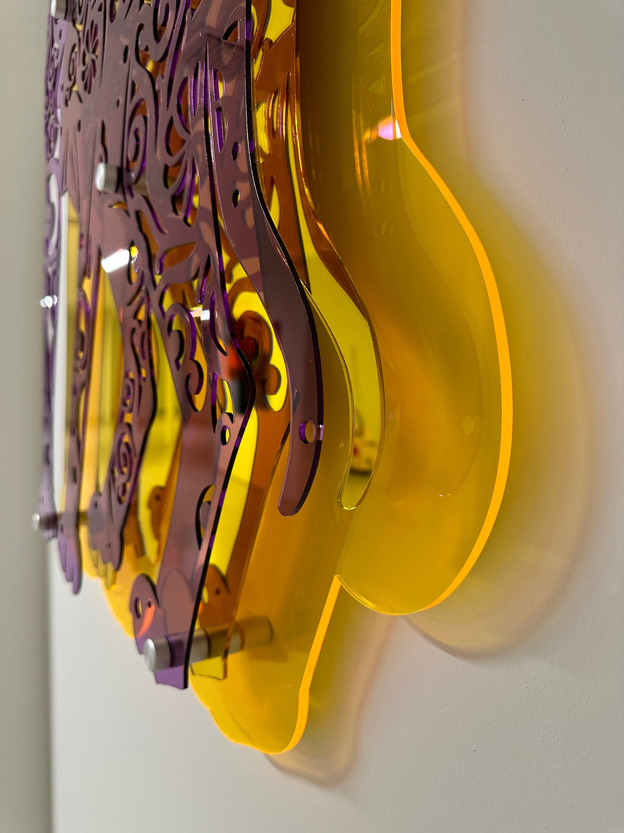 Close-up of uniQstiQ’s 3D Cat wall sculpture—a large, transparent Sphynx cat art piece in mirrored acrylic, ideal for contemporary decor and displayed on a white wall.