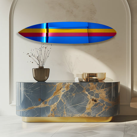 A modern marble cabinet with gold accents, vase, and decor sits beneath the uniQstiQ Retro Surfboard Wall Art—a vibrant 80s-inspired mirrored acrylic wall sculpture.